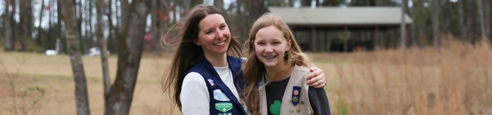  volunteer and Girl Scouts laugh in Fall 