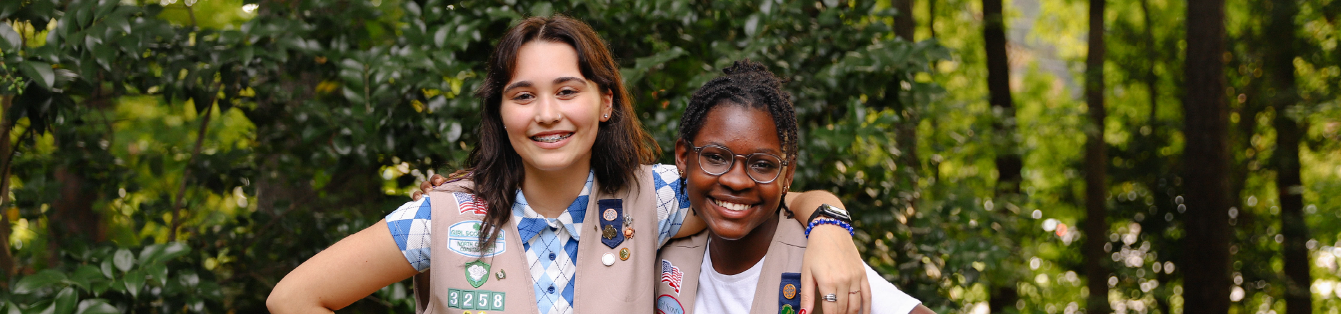  Group of Junior Girl Scouts smiling and laughing outdoors 