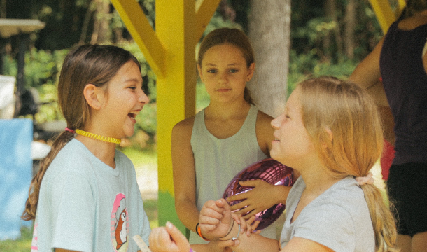 Two Girl Scouts at camp playing together