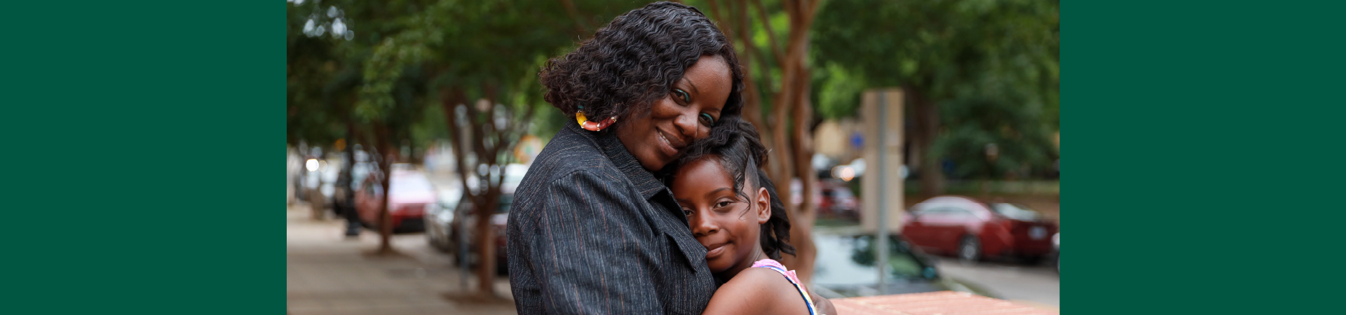  mother and daughter in big hug outside 