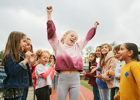 group of adult women hold signs and pose at photobooth